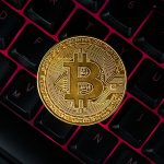 Bitcoin On Compuer Keyboard In Background, Symbol Of Electronic